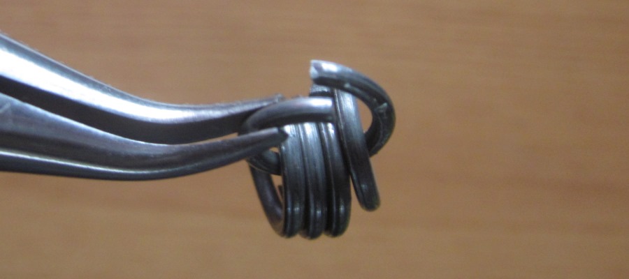 5 rings held in pliers