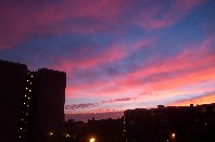 Silhouette of buildings against red sky